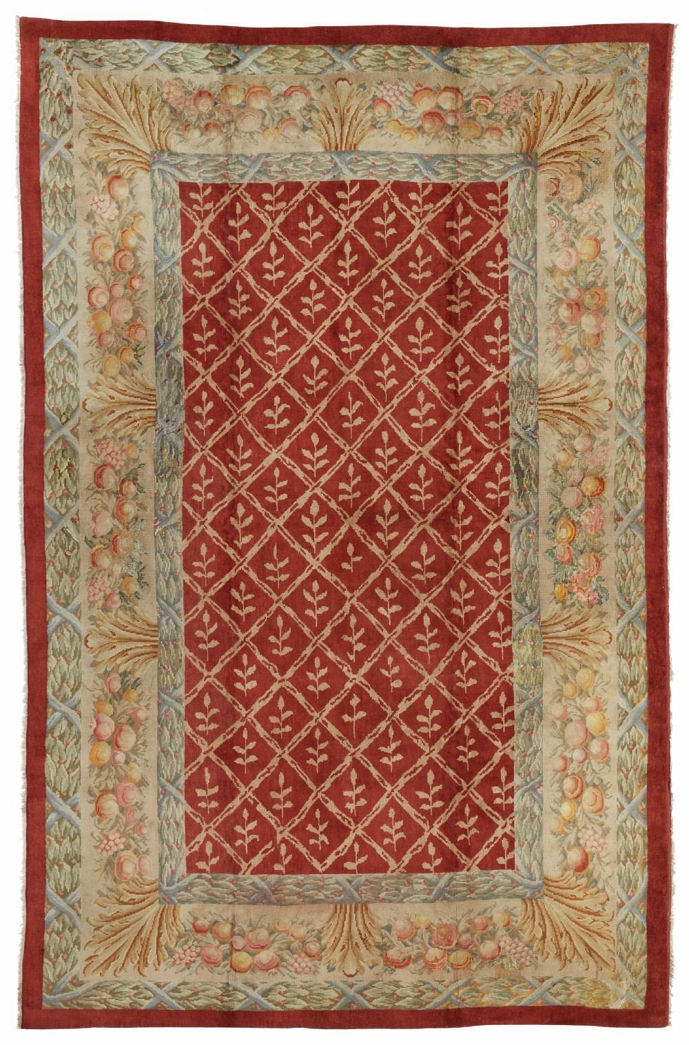 An Arts and Crafts Donegal hand-knotted wool carpet featuring a central red diamond trellis pattern bordered by soft green and cream botanical foliage.