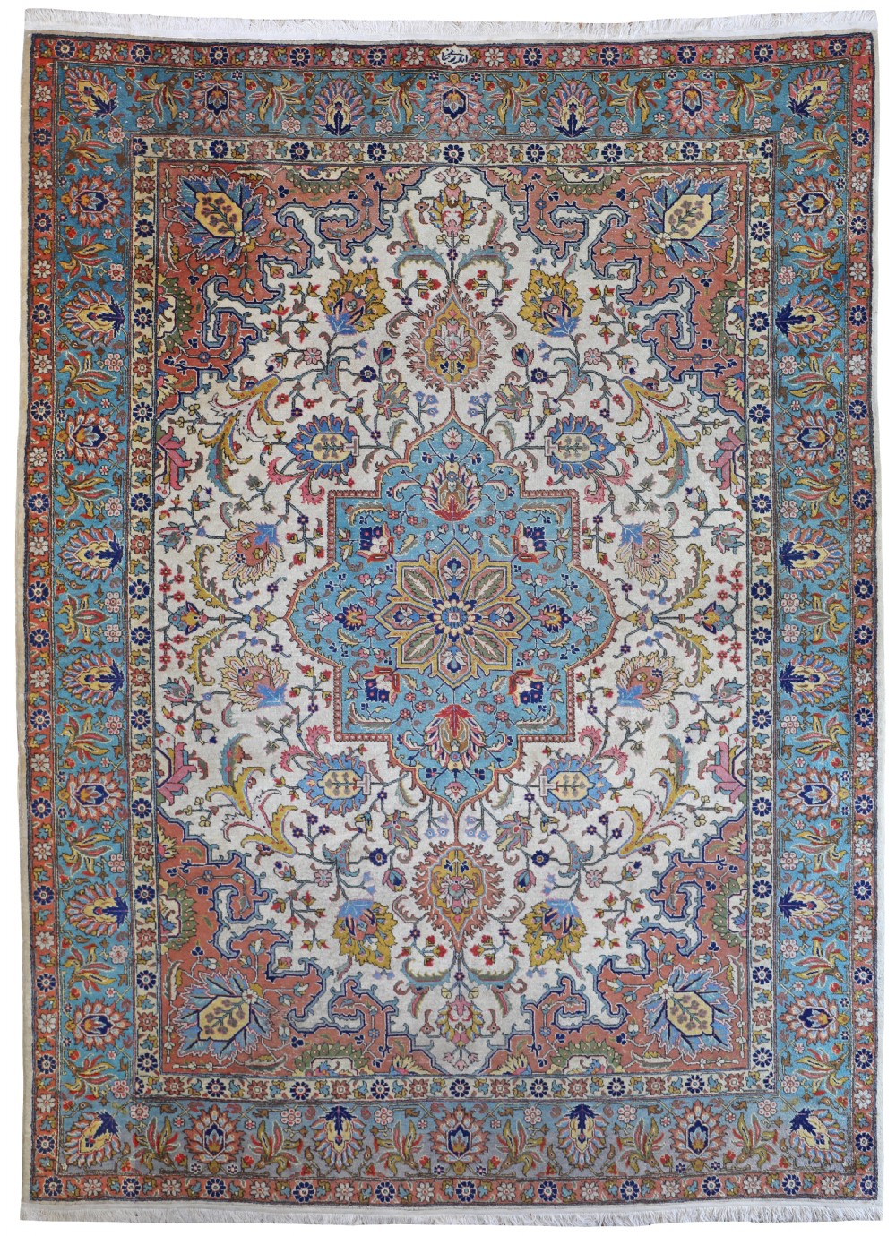An antique hand-knotted Persian Tabriz carpet featuring a central star medallion framed by floral arabesques on an ivory field with light blue and terracotta borders.
