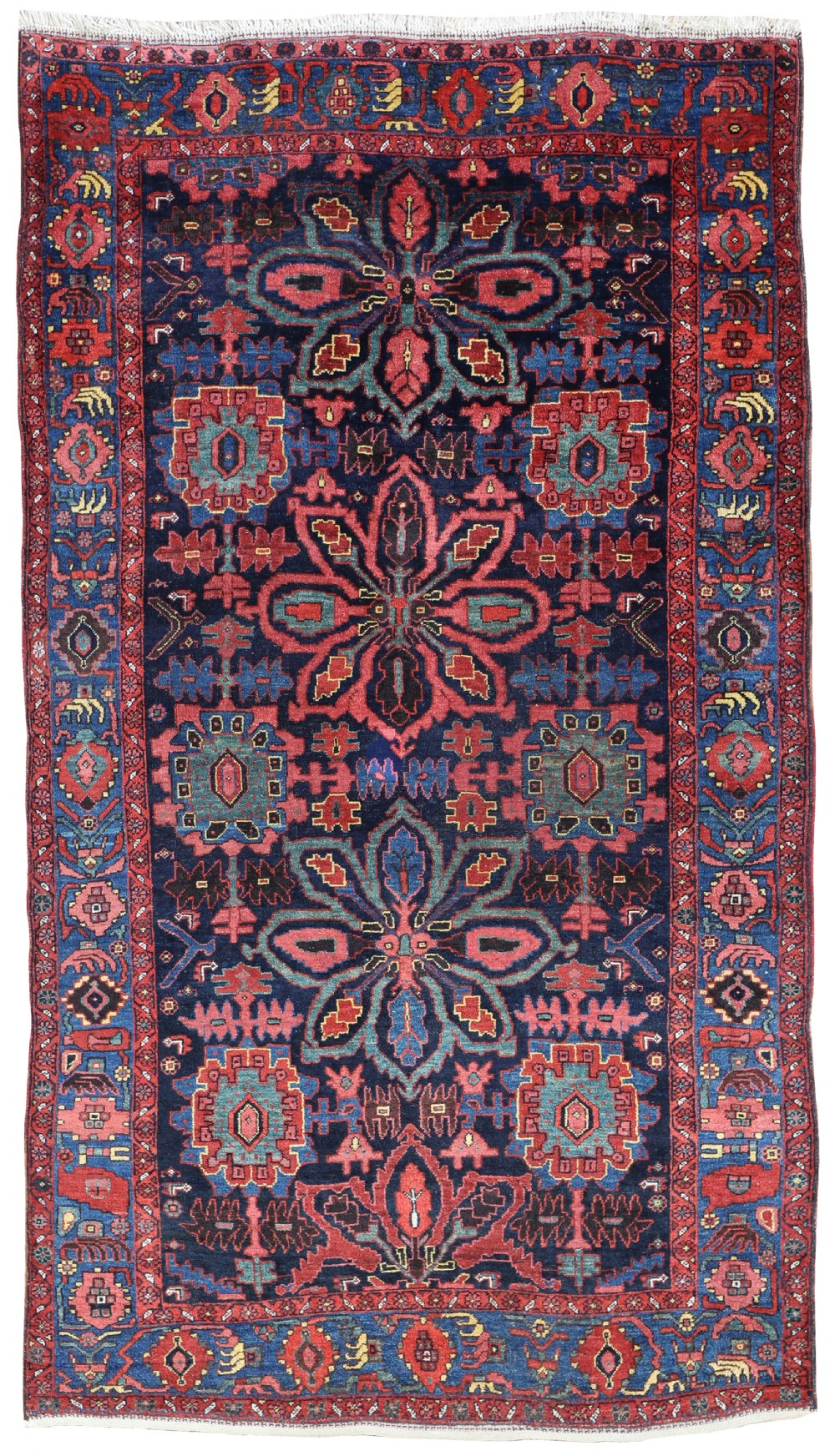 A rectangular hand-knotted wool rug featuring prominent central floral palmette motifs on a navy blue ground framed by decorative red borders.