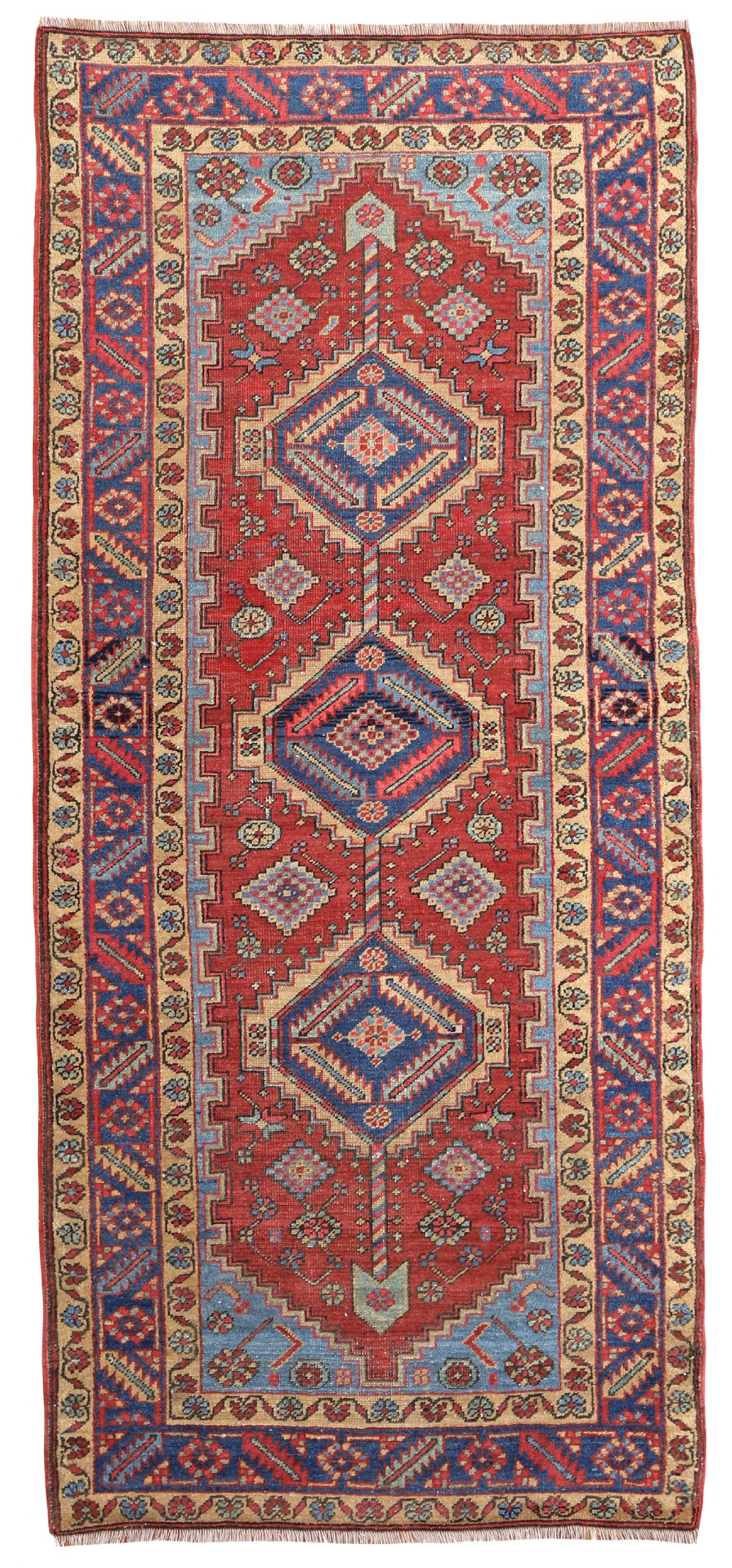 An antique hand-knotted Persian Heriz runner rug featuring a red field, geometric blue medallions, sky blue spandrels, and a multi-tiered patterned border.
