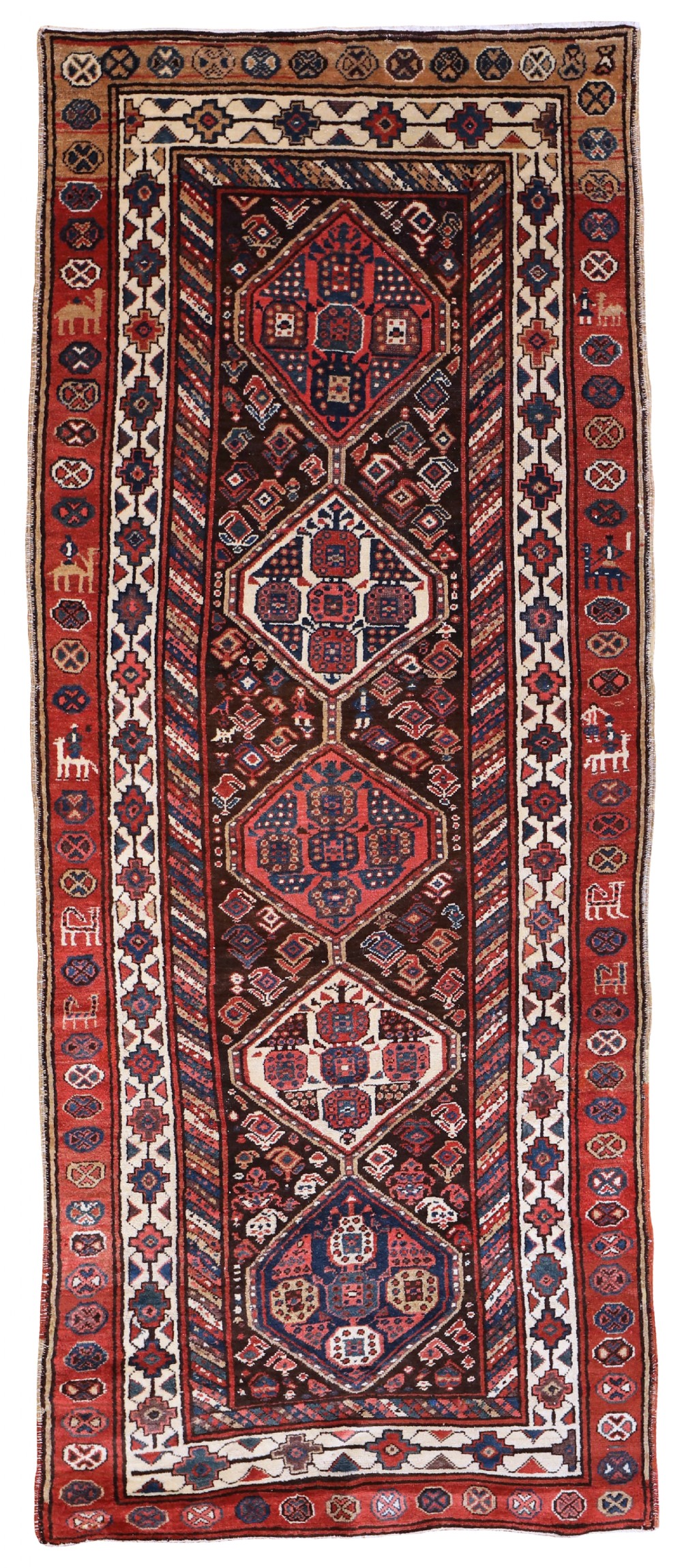 An antique hand-knotted Shahsavan wool runner featuring geometric diamond medallions on a dark brown field framed by red and ivory patterned borders.