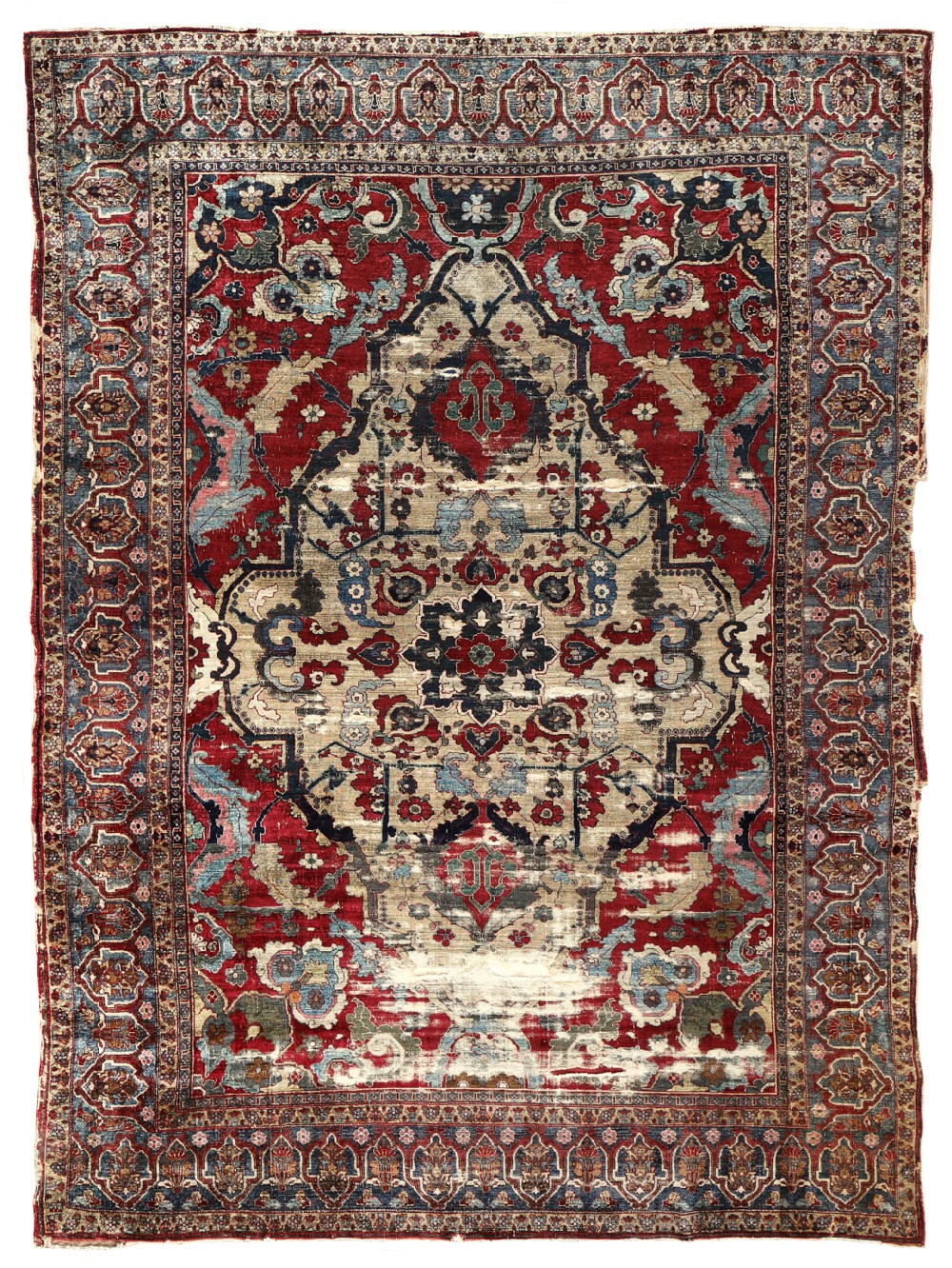 An antique silk Senneh carpet featuring an intricate dark central medallion on a beige field surrounded by red and blue floral borders.