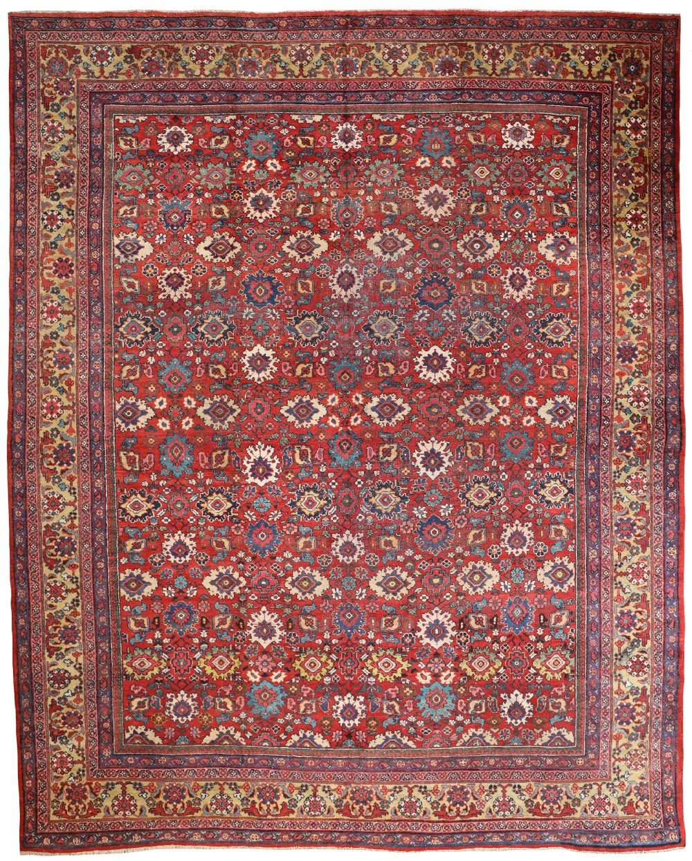 An antique Persian Mahal hand-knotted wool carpet featuring an all-over floral palmette design on a red field framed by a multi-band geometric border.