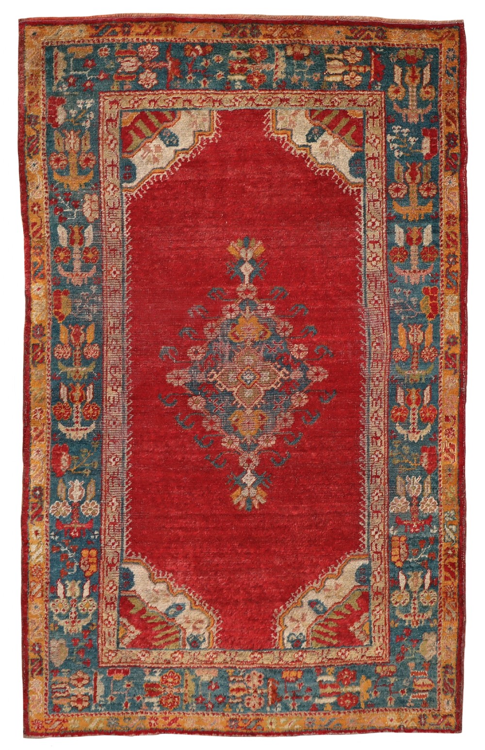 An antique hand-knotted Ushak wool rug featuring a central red field with a geometric medallion, framed by stylized spandrels and an intricate blue floral border.