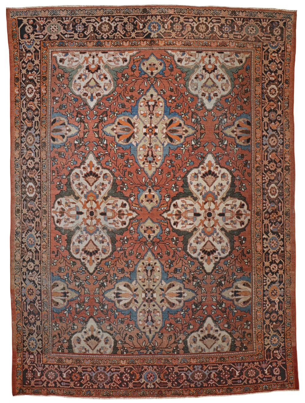 An antique Persian Mahal hand-knotted wool carpet featuring terracotta, soft blue, and cream floral medallions surrounded by a dark detailed border.