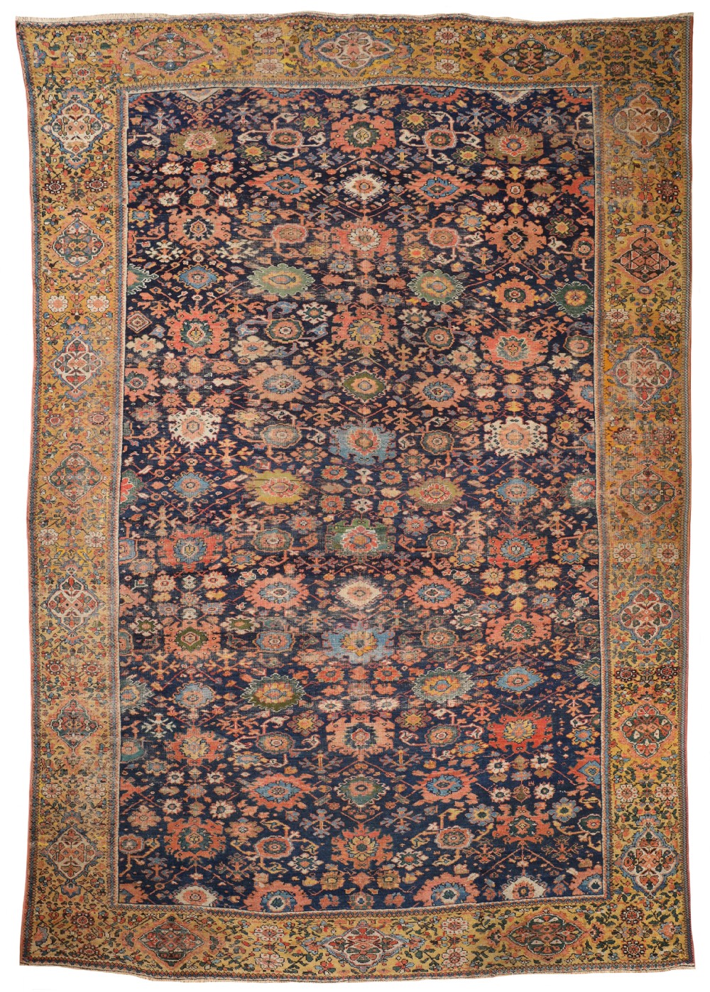 An antique rectangular Farahan carpet featuring a dark navy central field covered in intricate colourful floral motifs, enclosed within a wide mustard yellow patterned border.