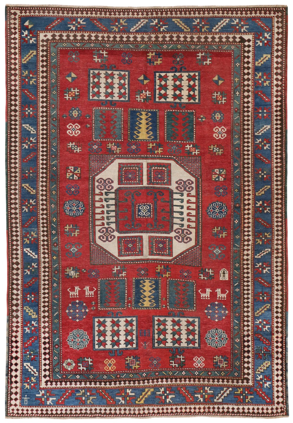 An antique Caucasian Kazak wool rug featuring a central red field with a geometric octagonal medallion, surrounded by blue borders and small animal motifs.