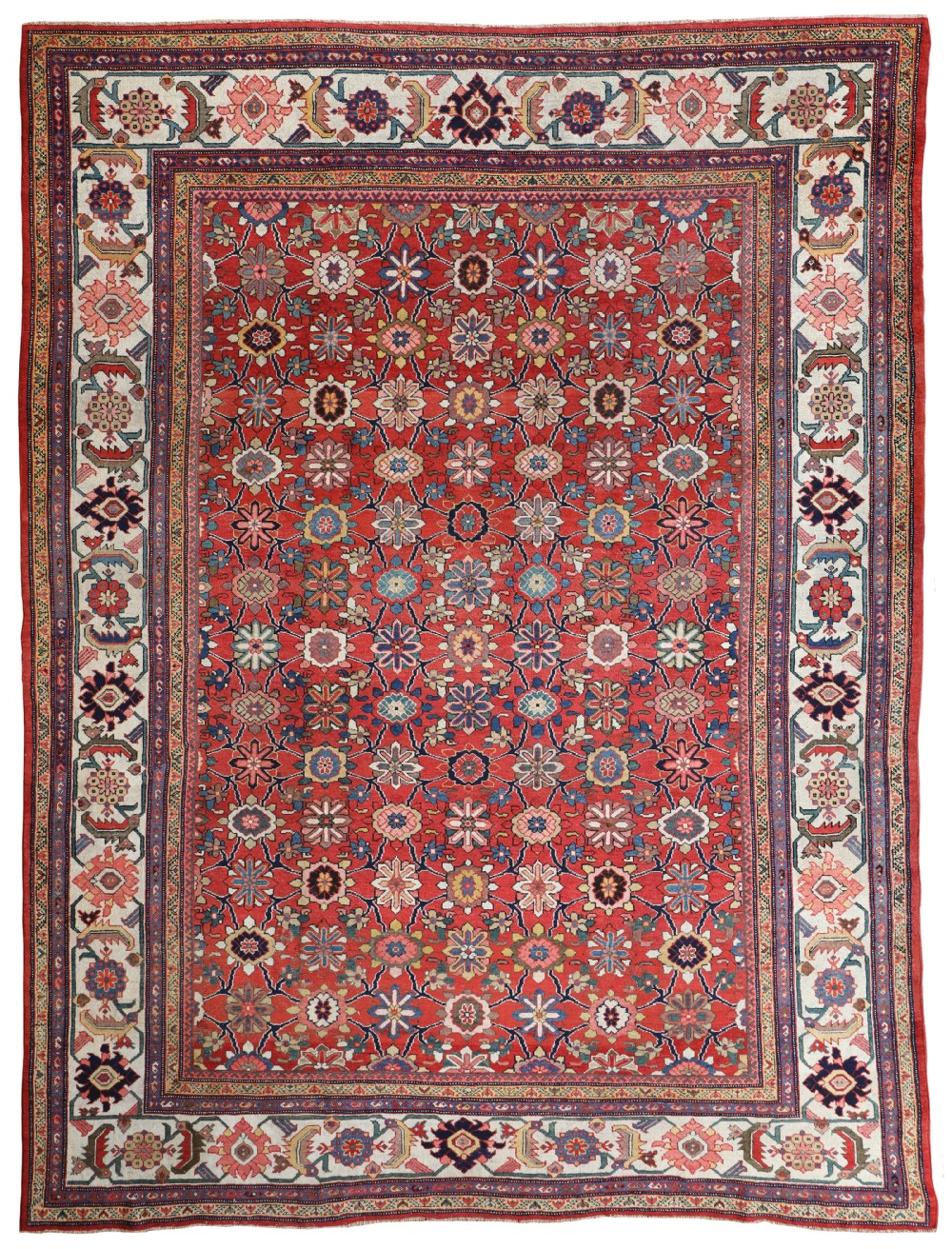 An antique hand-knotted Sultanabad carpet featuring an all-over repeating floral motif on a terracotta red field, framed by a cream and navy patterned border.