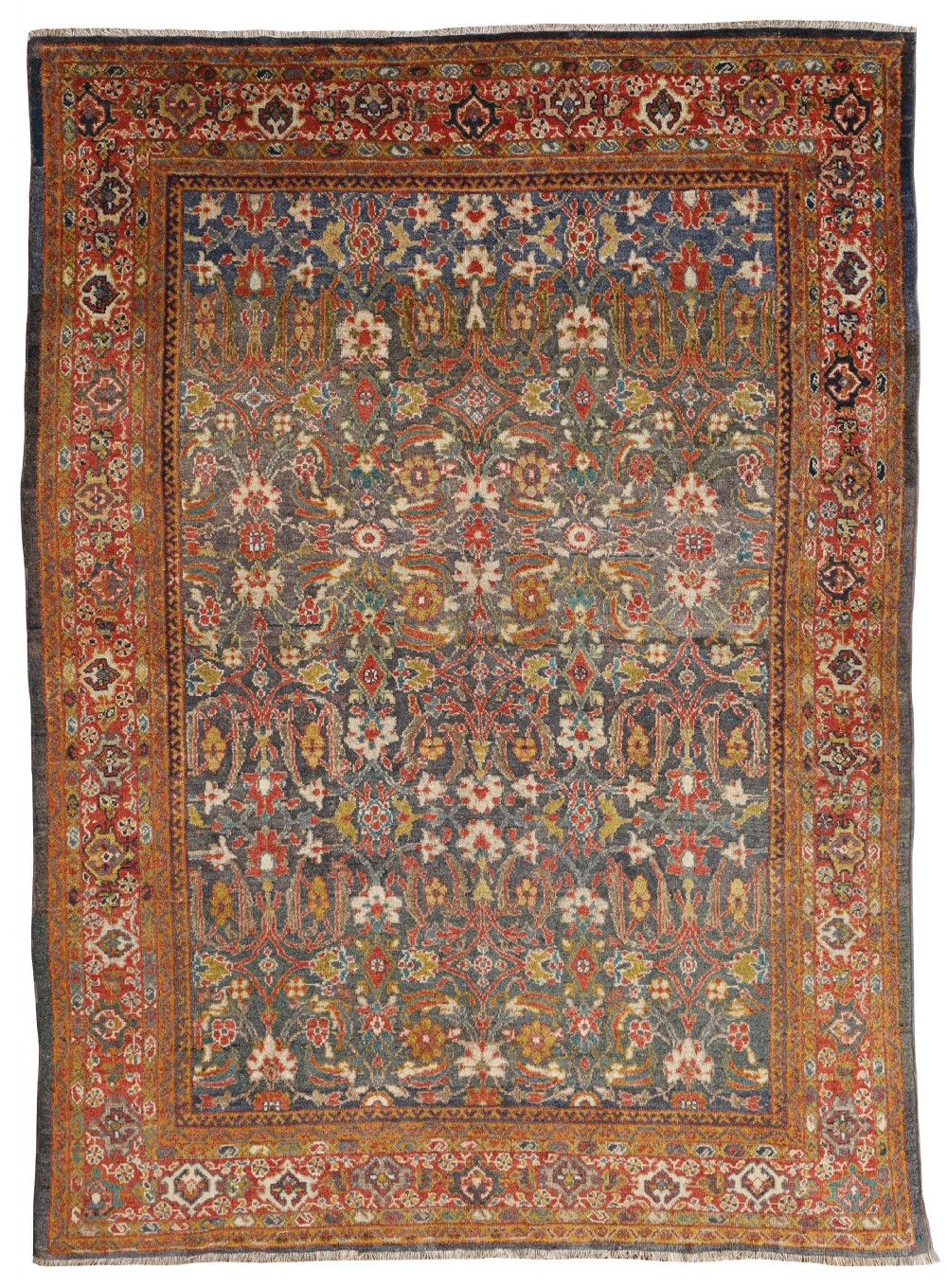An antique hand-knotted Ziegler wool carpet with floral palmette patterns in slate blue, terracotta red, ochre, and ivory framed by a layered decorative border.