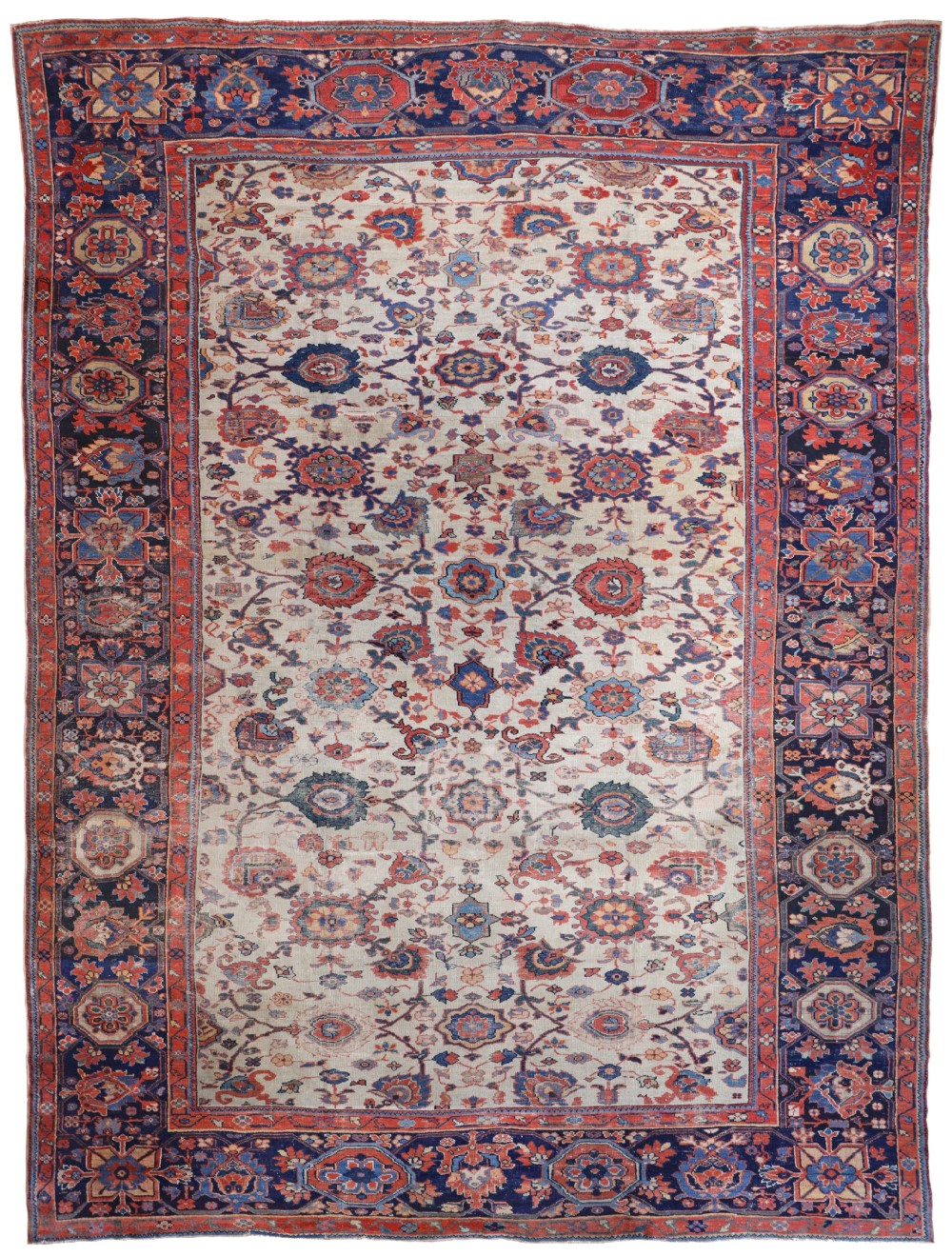 An antique hand-knotted Persian Ziegler carpet featuring a cream field decorated with floral motifs, framed by a dark indigo blue patterned border.