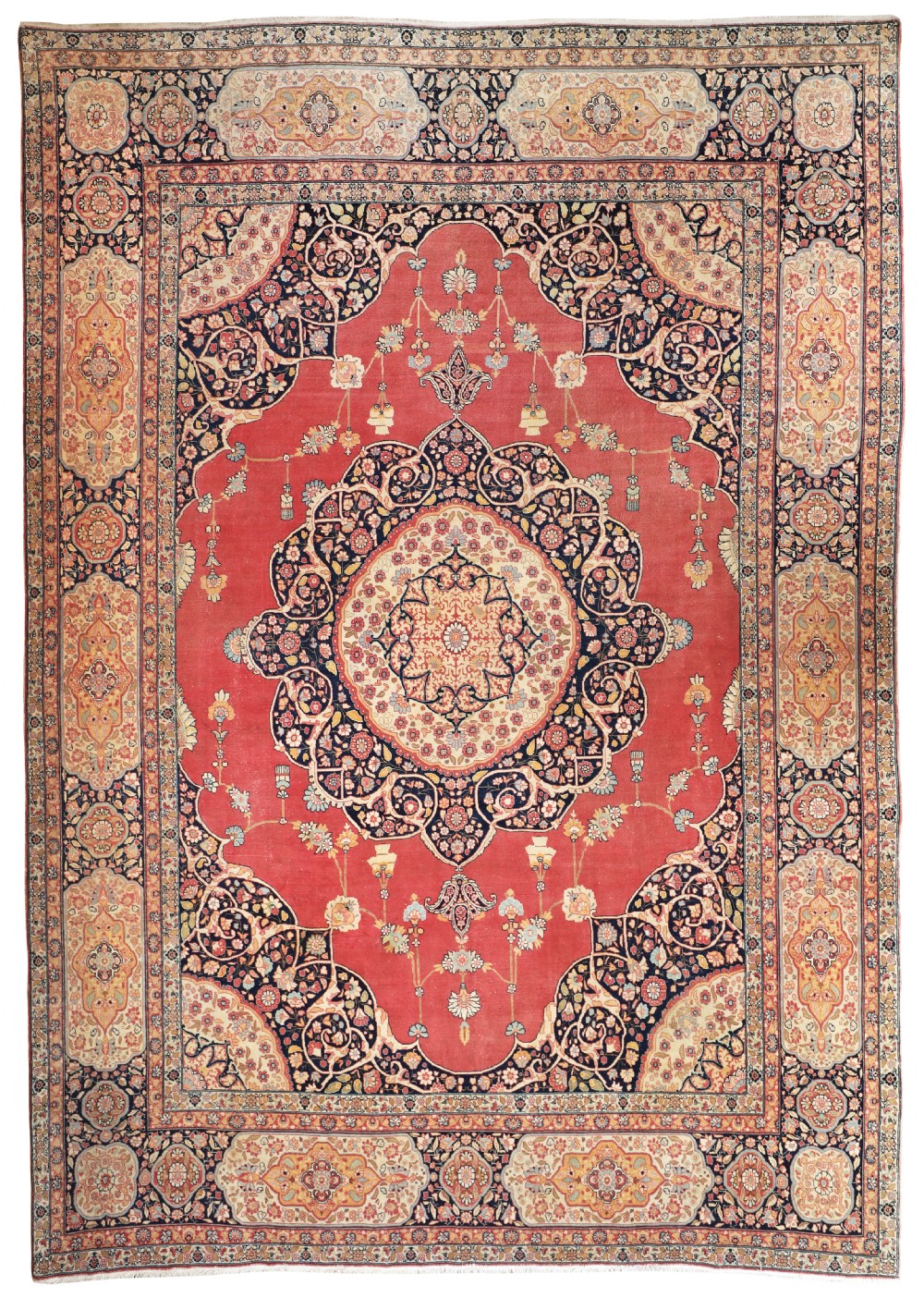 An antique hand-knotted Tabriz carpet featuring a central lobed medallion on a terracotta red field framed by blue spandrels and ornate floral borders.