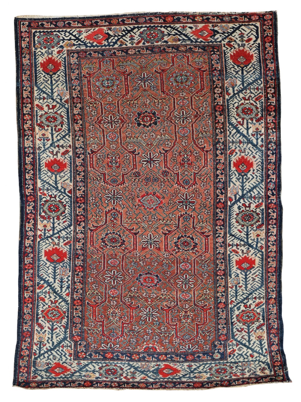 An antique hand-knotted Kurdish wool rug featuring a terracotta red centre field with geometric star motifs enclosed by a patterned navy blue and cream border.