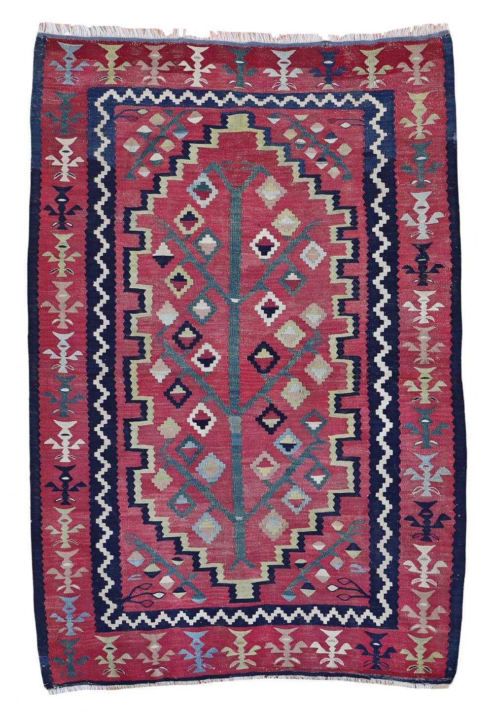 An antique Sarkoy wool kilim featuring a central green tree motif on a crimson ground surrounded by stepped geometric borders.
