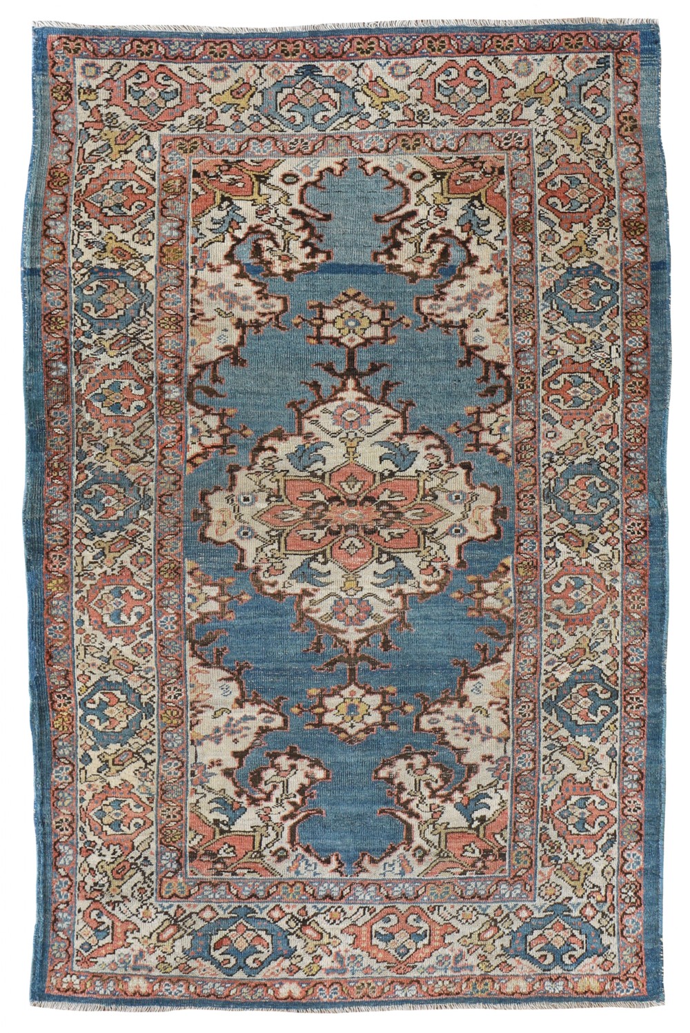 An antique hand-knotted Ziegler rug featuring a blue central field with a floral medallion surrounded by intricate ivory and terracotta floral borders.
