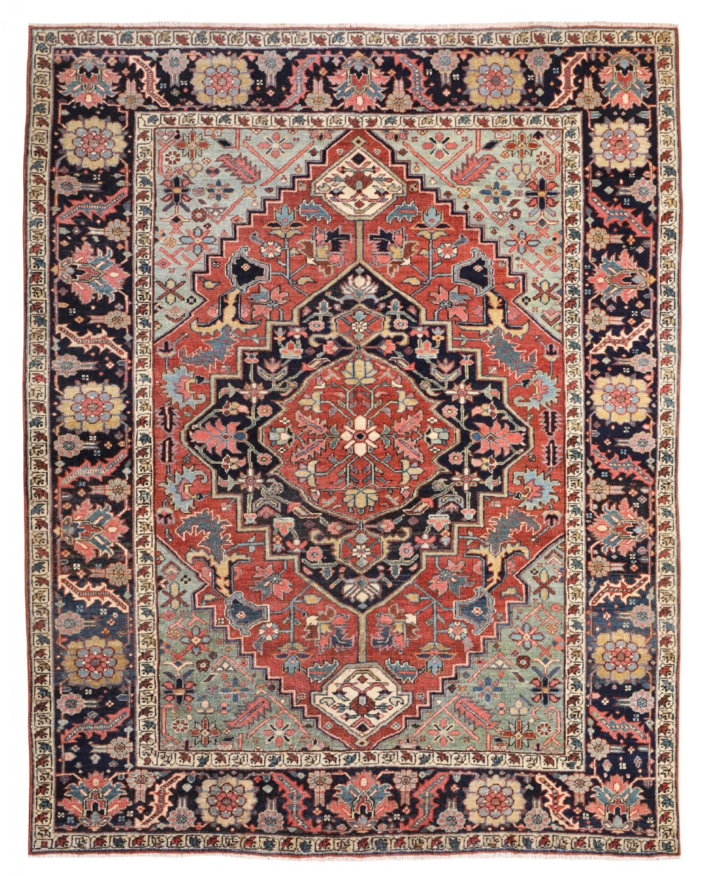 An antique hand-knotted Heriz wool carpet featuring a prominent central geometric medallion in rust red and navy blue surrounded by a soft blue spandrel and decorative borders.