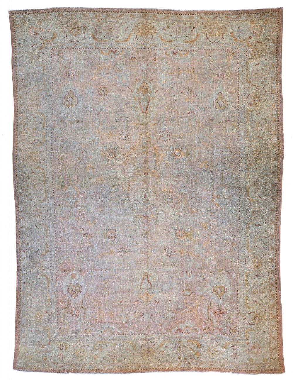 An antique Ushak wool carpet featuring a muted terracotta and sage central field with floral palmette motifs and a decorative multi-tiered border.