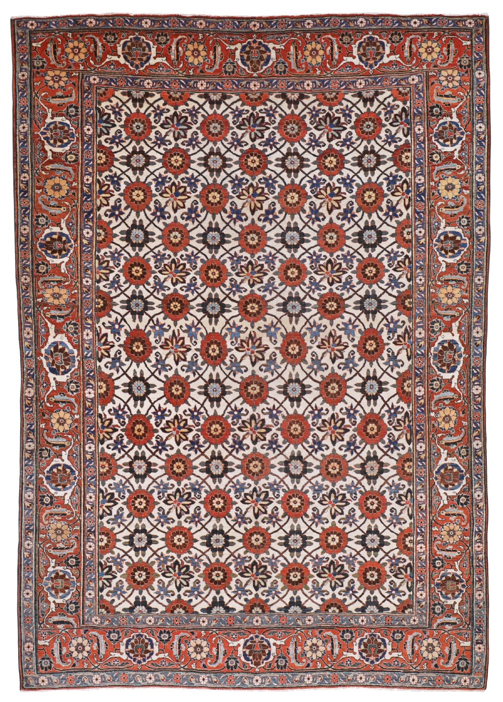 An antique hand-knotted Persian Veramin carpet featuring a repeating floral lattice pattern in terracotta red and navy blue over an ivory field with an elaborate floral border.