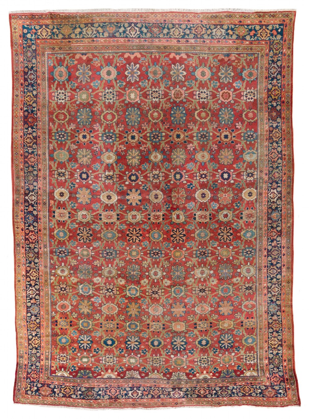 An antique Sultanabad hand-knotted wool carpet featuring an all-over repeating geometric floral pattern on a terracotta red field with a dark blue patterned border.
