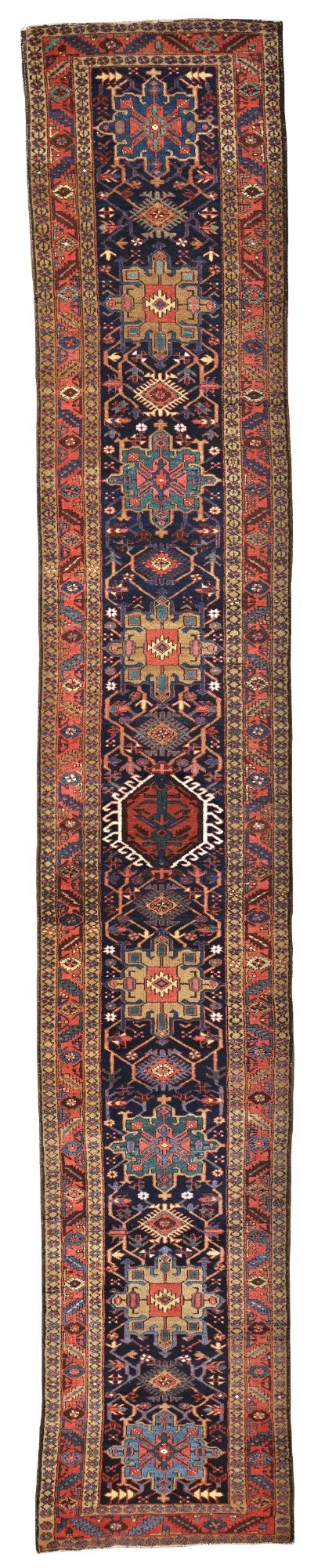An antique Karaja hand-knotted wool runner featuring geometric blue and terracotta medallions on a dark navy field. View X