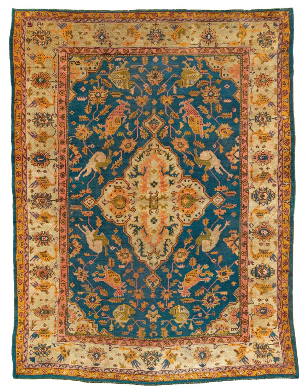 A hand-knotted wool carpet featuring a deep blue central field with a cream diamond medallion and multi-coloured stylized bird motifs surrounded by intricate borders.