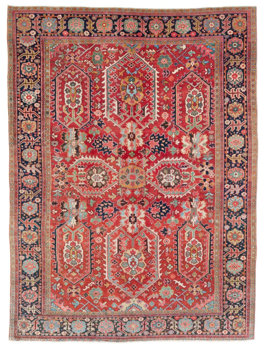 An antique hand-knotted Persian Heriz wool carpet featuring a red central field decorated with geometric motifs surrounded by a dark navy patterned border.