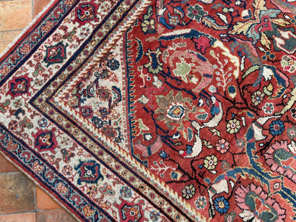 A hand-knotted antique Persian Mahal carpet featuring a terracotta red field with intricate floral motifs surrounded by cream and navy decorative borders. View II