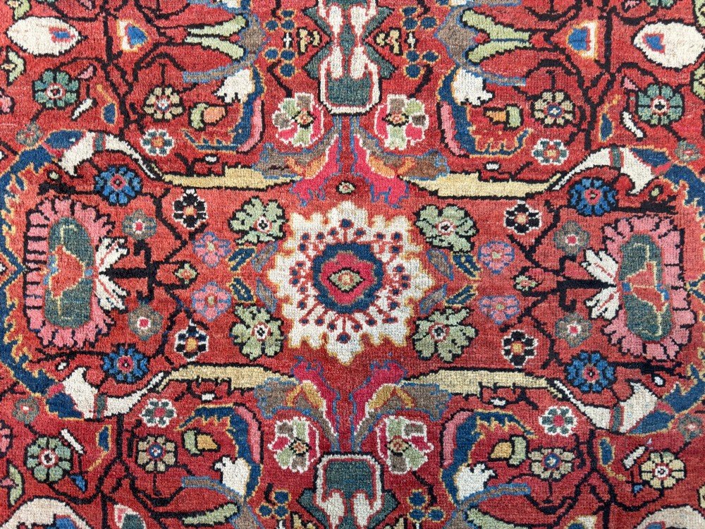 A hand-knotted antique Persian Mahal carpet featuring a terracotta red field with intricate floral motifs surrounded by cream and navy decorative borders. View XII