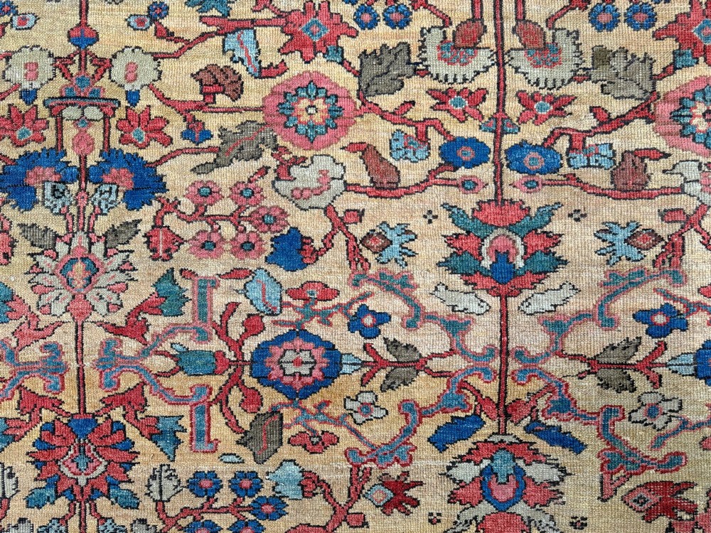 An antique Farahan Persian wool carpet with a yellow floral field framed by a dark navy decorative border. View III