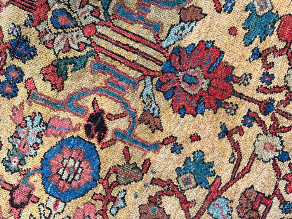 An antique Farahan Persian wool carpet with a yellow floral field framed by a dark navy decorative border. View IX
