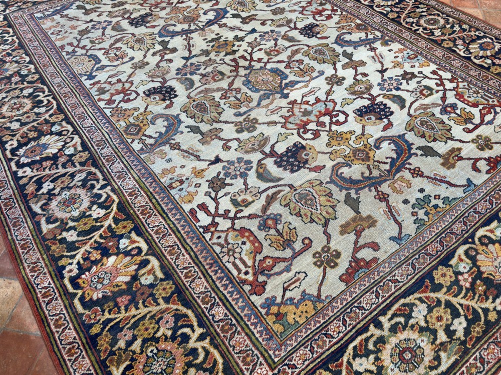 An antique hand-knotted Persian Mahal carpet featuring an ivory ground decorated with intricate floral vines and framed by a dark navy decorative border. View II