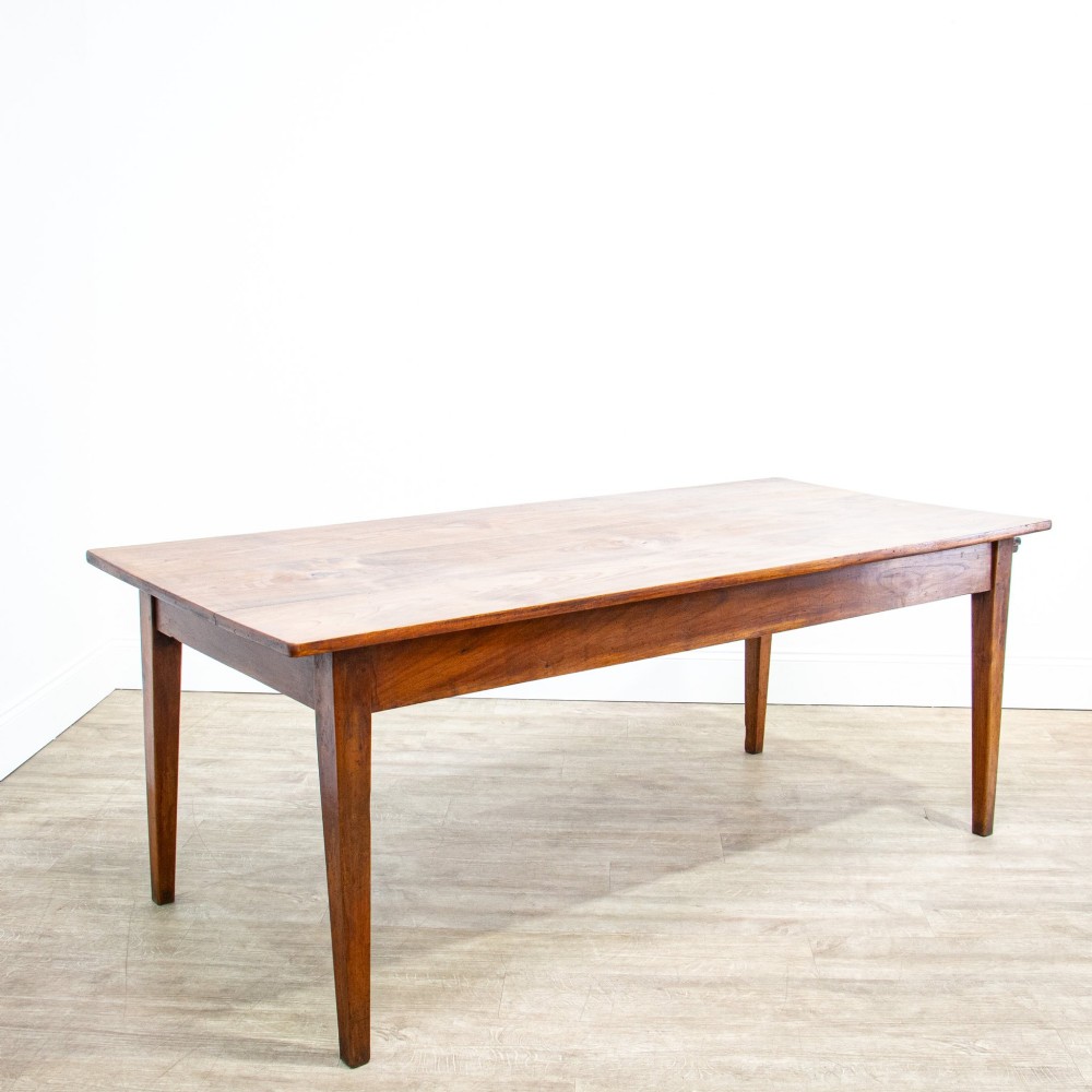 A 19th-century French fruitwood farmhouse dining table featuring a rectangular plank top, tapered square legs, and a single frieze drawer. View VI