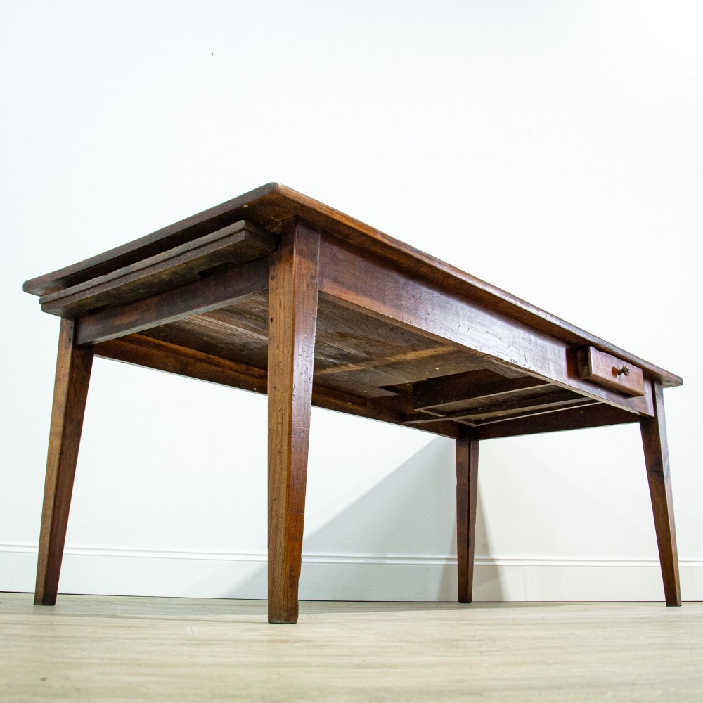 A 19th-century French fruitwood farmhouse dining table featuring a rectangular plank top, tapered square legs, and a single frieze drawer. View XI