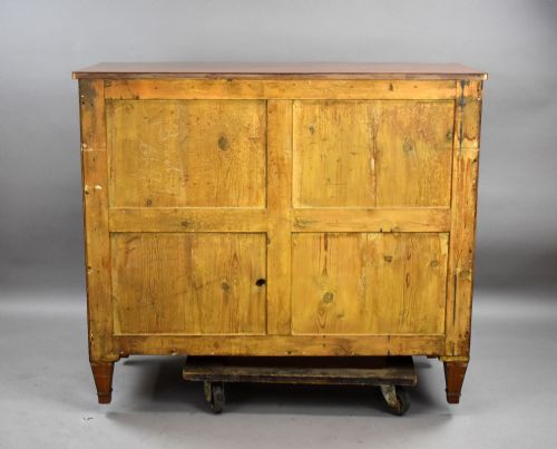 fig 4. A Regency period bowfront chest of four graduated drawers constructed from golden satinwood with crossbanded borders and turned brass knobs.
