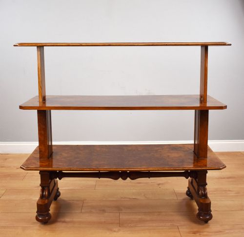 fig 2. A Victorian burr walnut three-tier telescopic dumbwaiter featuring adjustable shelves resting on carved trestle supports.