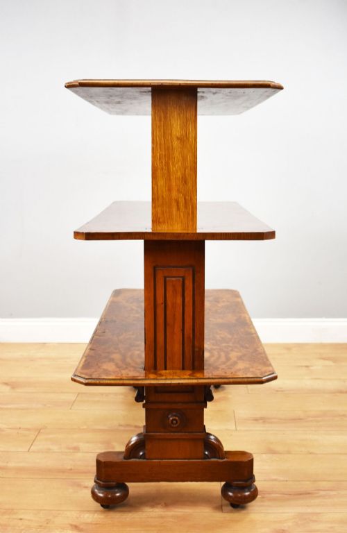 fig 3. A Victorian burr walnut three-tier telescopic dumbwaiter featuring adjustable shelves resting on carved trestle supports.