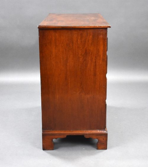 fig 2. A George III mahogany bachelors chest of drawers featuring four graduated drawers, a pull-out brushing slide, brass swan-neck handles, and bracket feet.