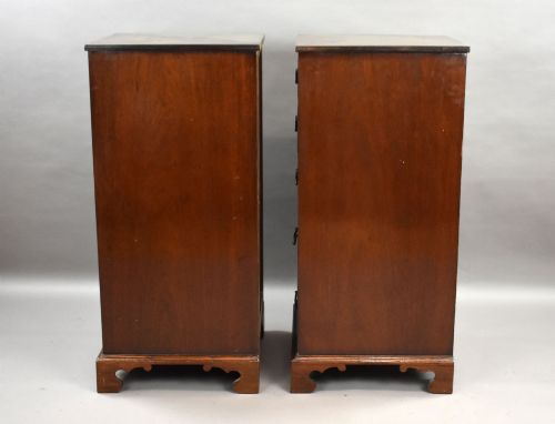 fig 1. A matching pair of tall, narrow mahogany bedside chests, each featuring five drawers with brass handles and resting on bracket feet.
