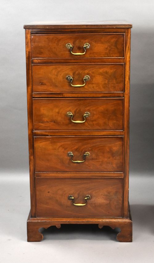 fig 2. A matching pair of tall, narrow mahogany bedside chests, each featuring five drawers with brass handles and resting on bracket feet.