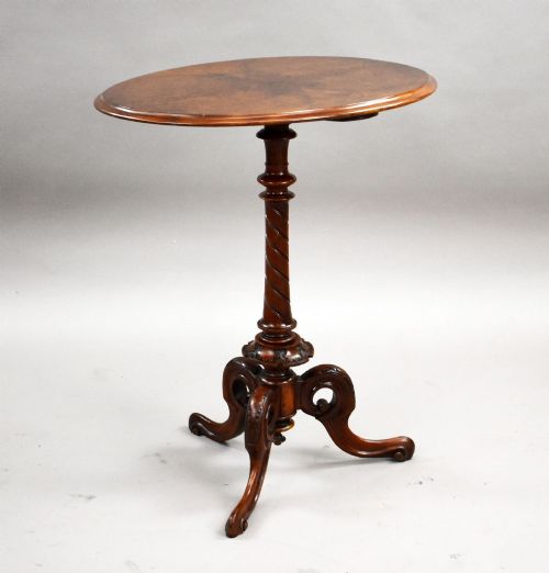 fig 1. A Victorian burr walnut occasional table featuring a figure-patterned top, a barley twist carved stem, and a carved tripod base.