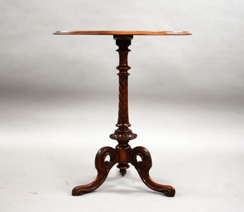 fig 2. A Victorian burr walnut occasional table featuring a figure-patterned top, a barley twist carved stem, and a carved tripod base.