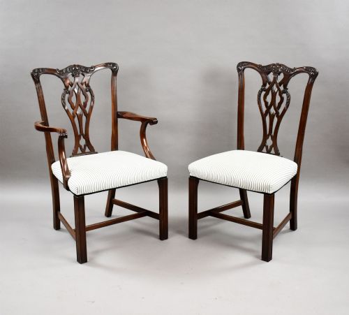 fig 2. An Edwardian mahogany extending dining table surrounded by matching Chippendale style dining chairs with striped upholstered seats and carved ball and claw feet.