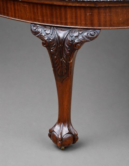 fig 4. An Edwardian mahogany extending dining table surrounded by matching Chippendale style dining chairs with striped upholstered seats and carved ball and claw feet.