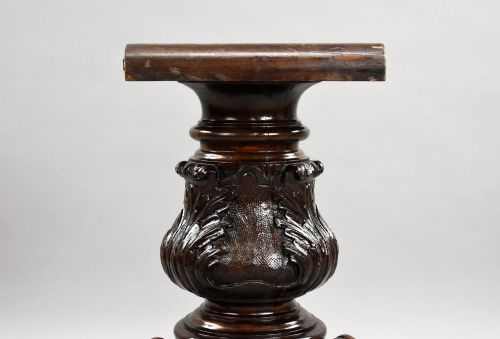 fig 5. A Victorian circular burr walnut centre table featuring floral marquetry inlays on the tabletop and a dark carved pedestal base.