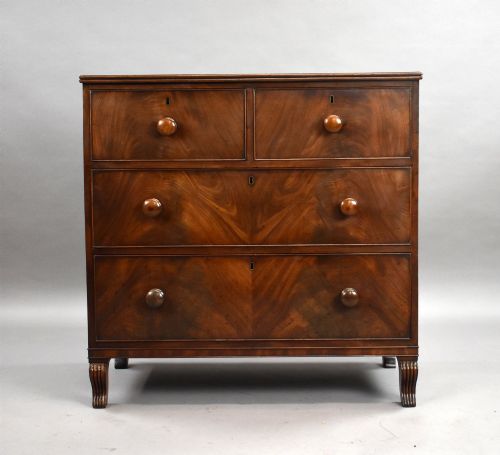fig 1. A Regency flame mahogany chest of drawers featuring two short over two long drawers with turned timber knobs and shaped bracket feet.