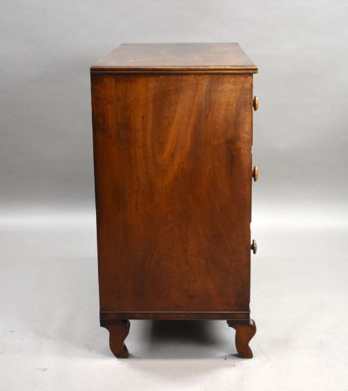 fig 2. A Regency flame mahogany chest of drawers featuring two short over two long drawers with turned timber knobs and shaped bracket feet.