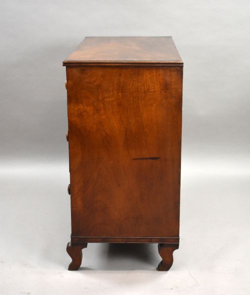 fig 3. A Regency flame mahogany chest of drawers featuring two short over two long drawers with turned timber knobs and shaped bracket feet.