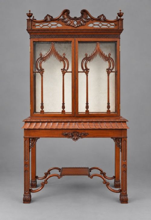 fig 1. A late Victorian mahogany display cabinet in the Chinese Chippendale style with a pierced cresting, glazed tracery doors, and carved legs with an under-tier.