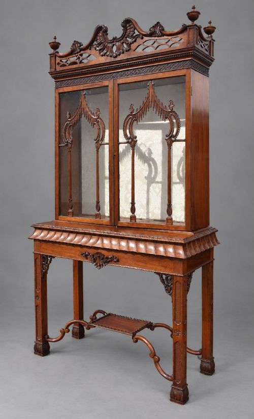 fig 2. A late Victorian mahogany display cabinet in the Chinese Chippendale style with a pierced cresting, glazed tracery doors, and carved legs with an under-tier.