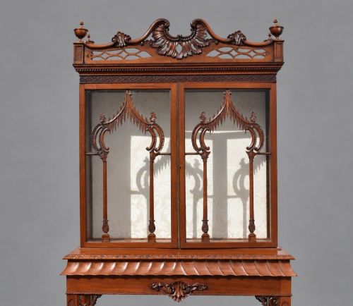 fig 3. A late Victorian mahogany display cabinet in the Chinese Chippendale style with a pierced cresting, glazed tracery doors, and carved legs with an under-tier.