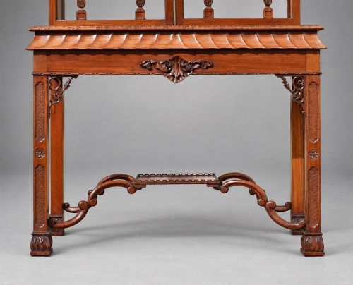 fig 4. A late Victorian mahogany display cabinet in the Chinese Chippendale style with a pierced cresting, glazed tracery doors, and carved legs with an under-tier.